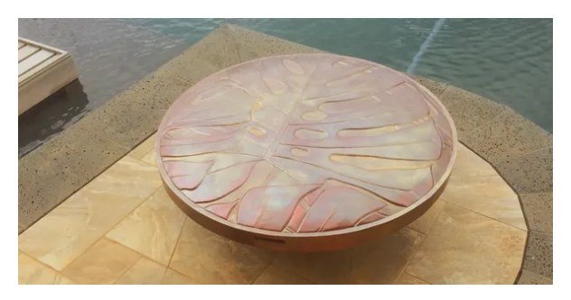 Custom fire bowl cover finished to match exterior monstera leaf wall sconces