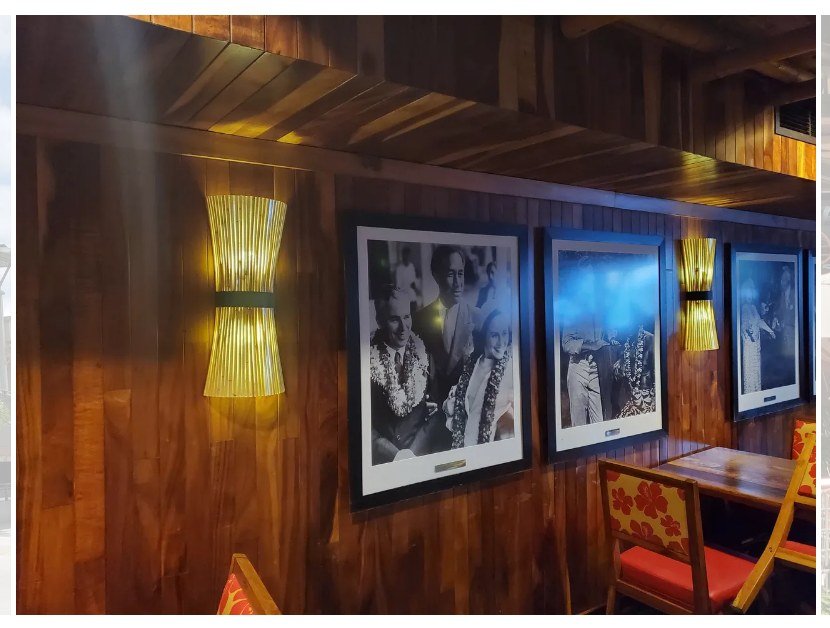 Hand-crafted wall sconces lighting a koa-paneled dining room at Duke's Waikiki