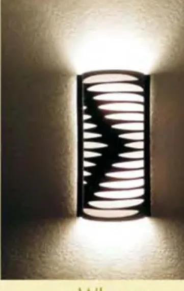 Wall sconce WL-204 lit, wave cutout pattern glowing on wall